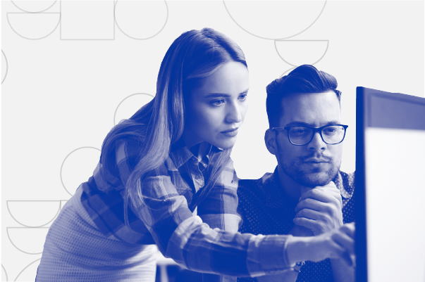 Two people working together on computer. 