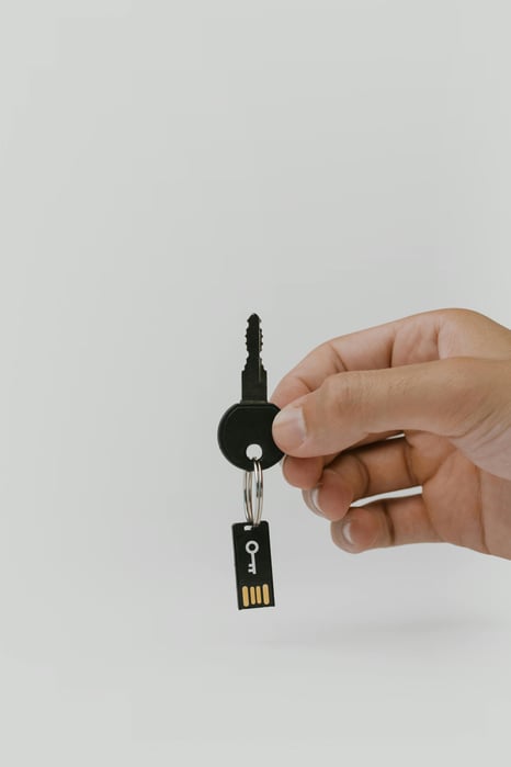 Hand holding key with flash drive